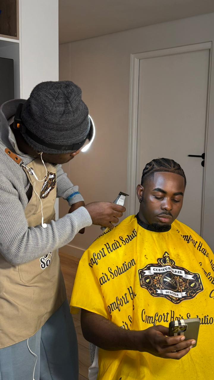 Professional barber giving a precise fade haircut